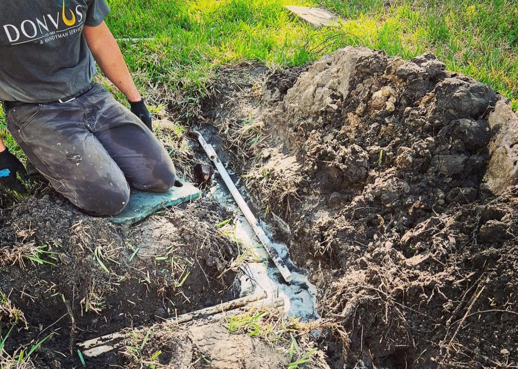 Don Vos employee working on sprinkler line